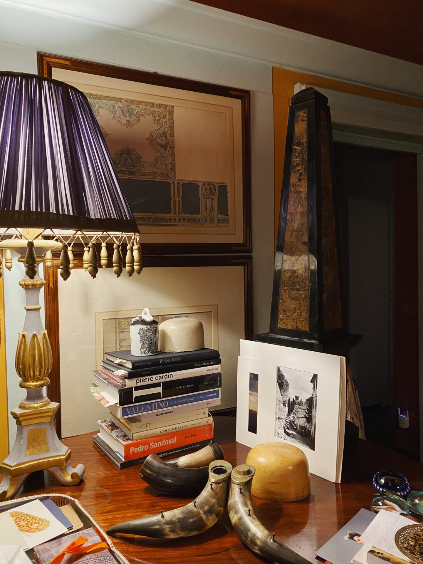 Rina Milano studio desk with books antique lamp and decoration in Florence Tuscany in Italy