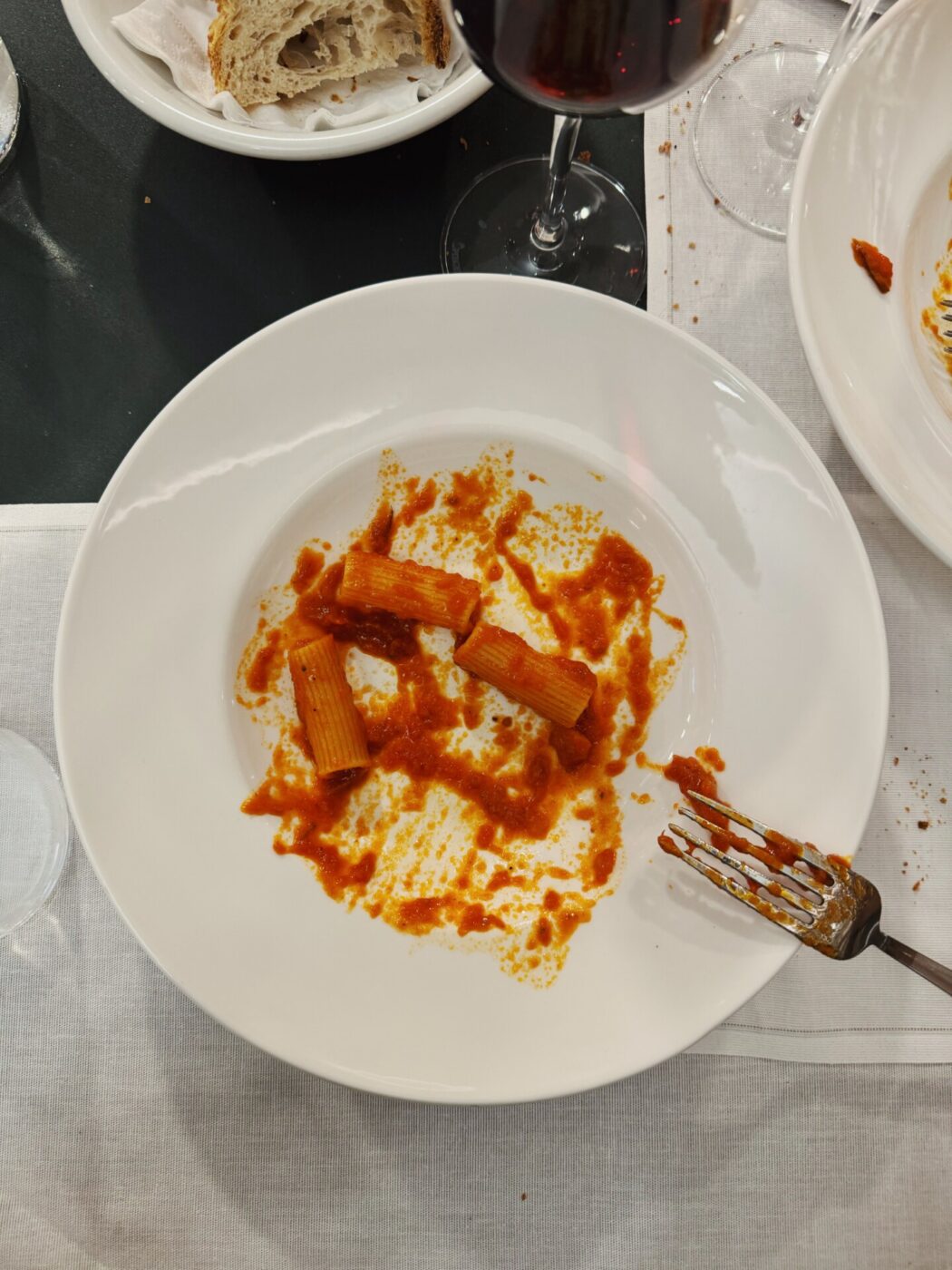 a half finished dish of rigatoni with red sauce