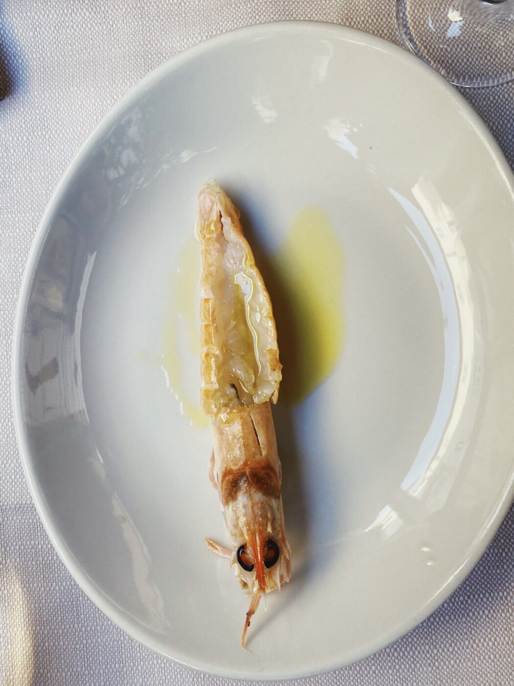 a shrimp served on a white plate