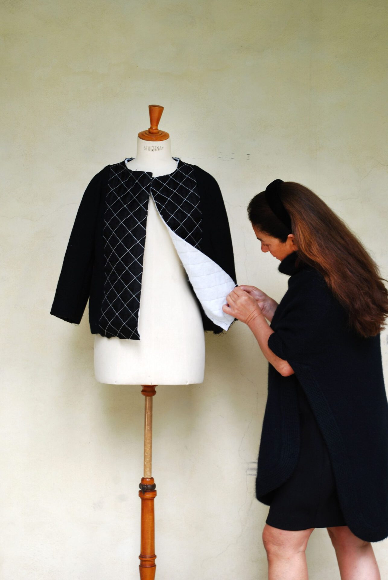Rina Milano black dressed designing a black dress over a manikin in Florence Tuscany in Italy