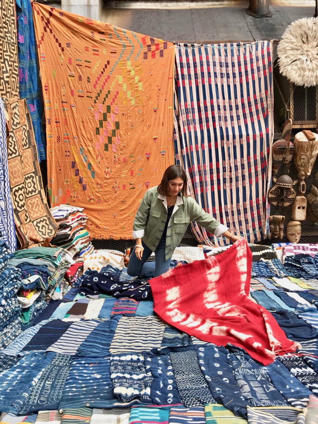 Pia Zanardi with and over colorful fabrics in Yali Tribe