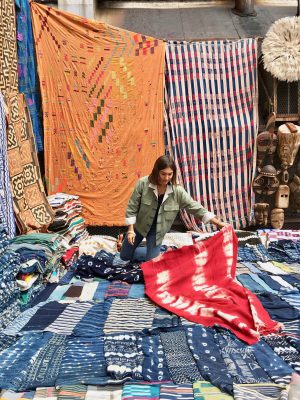 Pia Zanardi with and over colorful fabrics in Yali Tribe