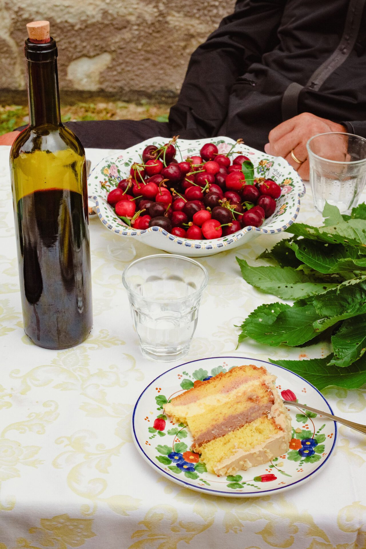 Italian table with plates and cherries wine cakes and glass cups in abruzzo Italy