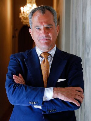 Leonardo Ferragamo with Blue suit and yellow tie arms crossed