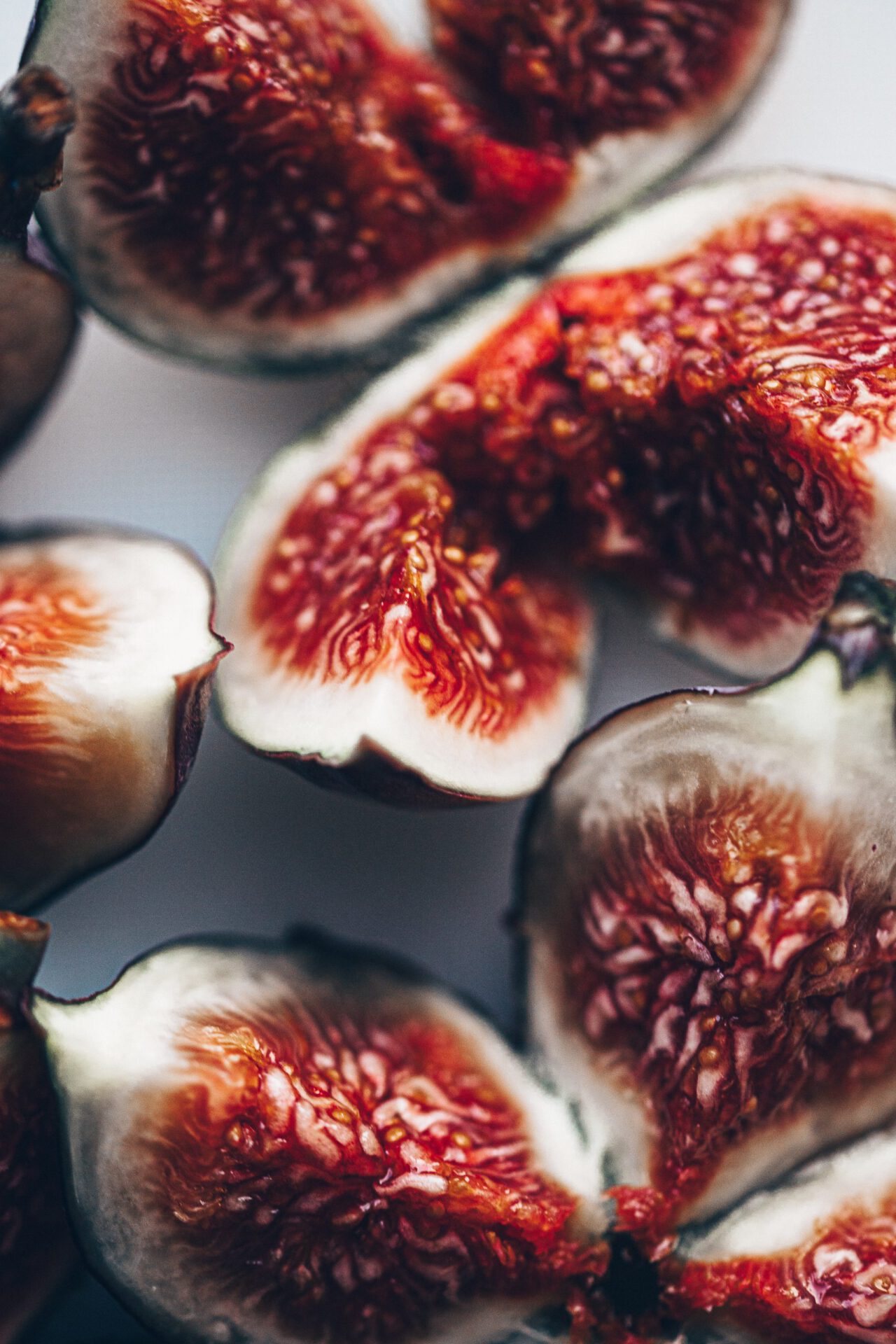 Opened figs with black peel and white red center full of seeds