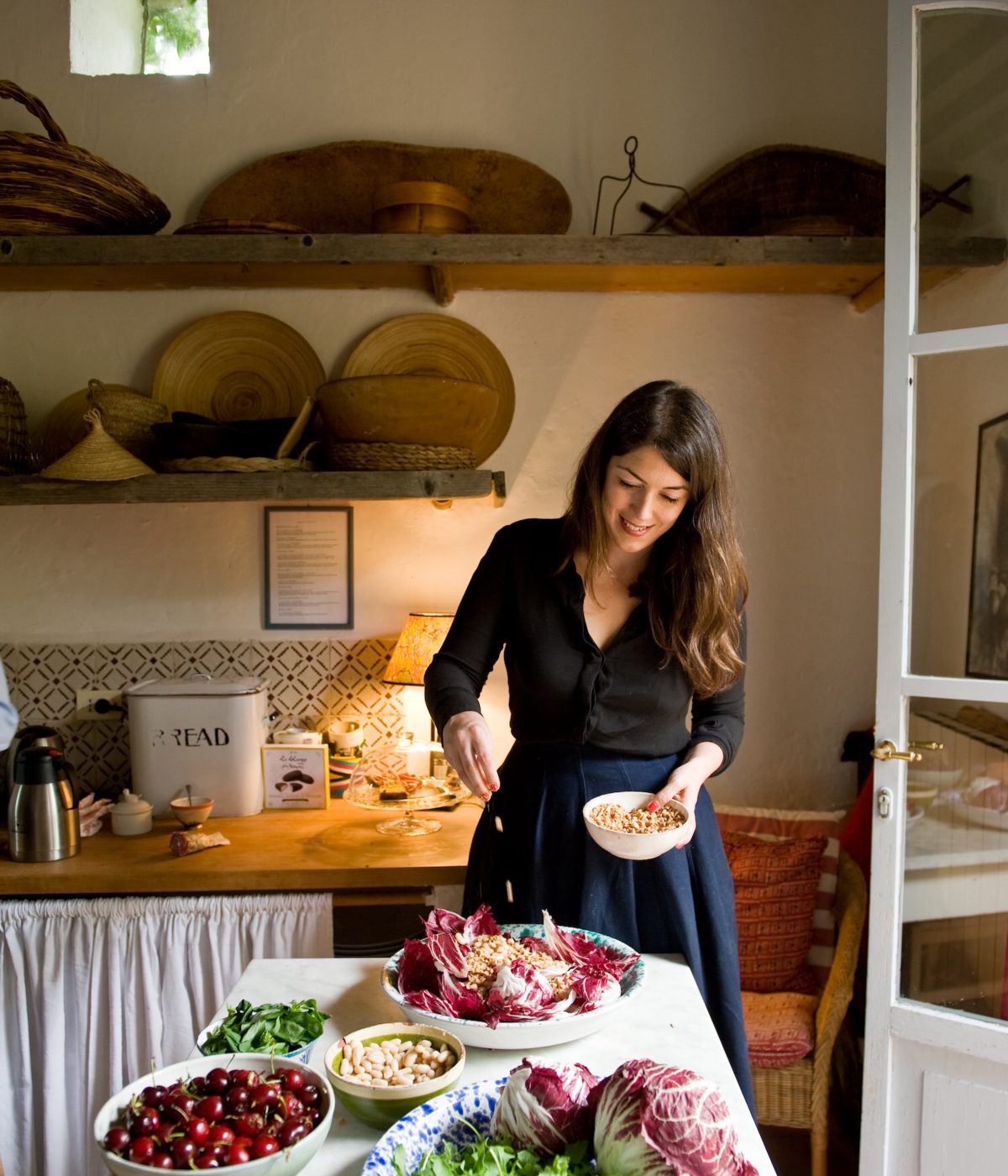 Amber Guiness cooking at kitchen with salad cherries and nuts in the Arniano Painting School in Tuscany Italy