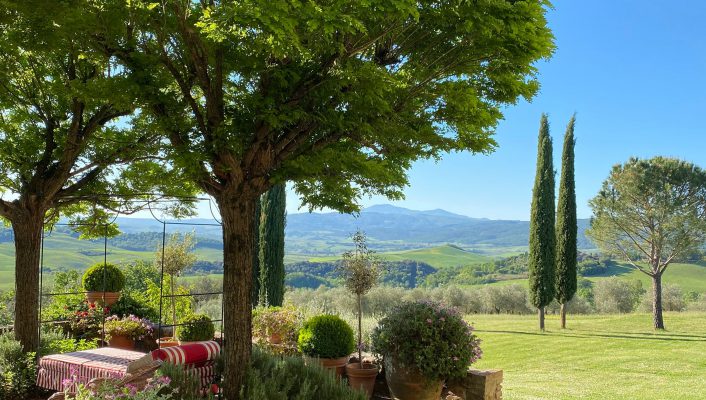Terrace with chairs and coach and sunset with green mountains background in the Arniano Painting School in Tuscany Italy