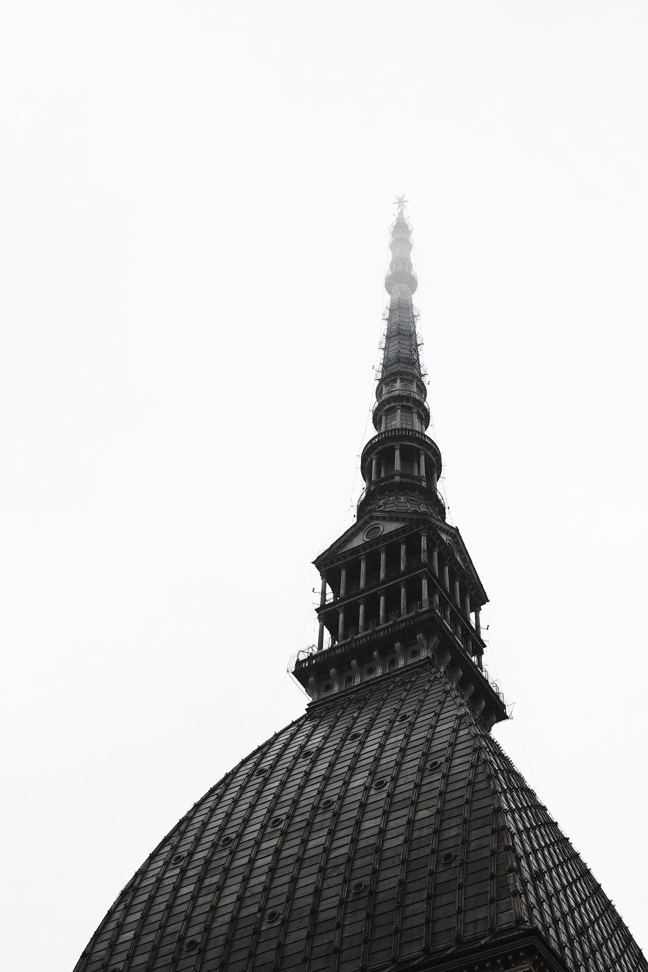 Top of the Mole Antonelliana building dome in black and white in Turin Piedmont in Italy