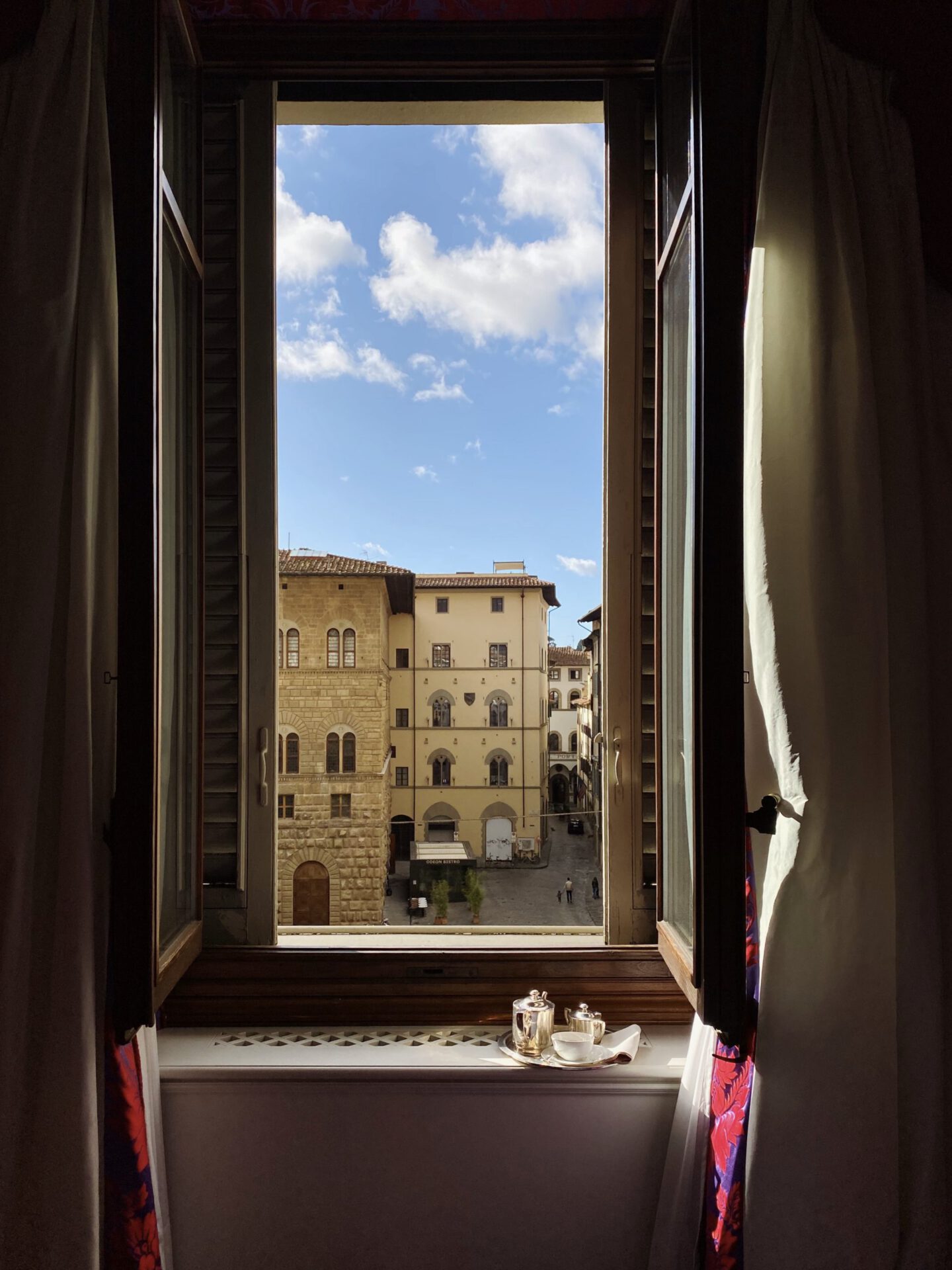 Antique buildings viewed from wooden window of the Helvetia & Bristol hotel in Florence Tuscany in Italy
