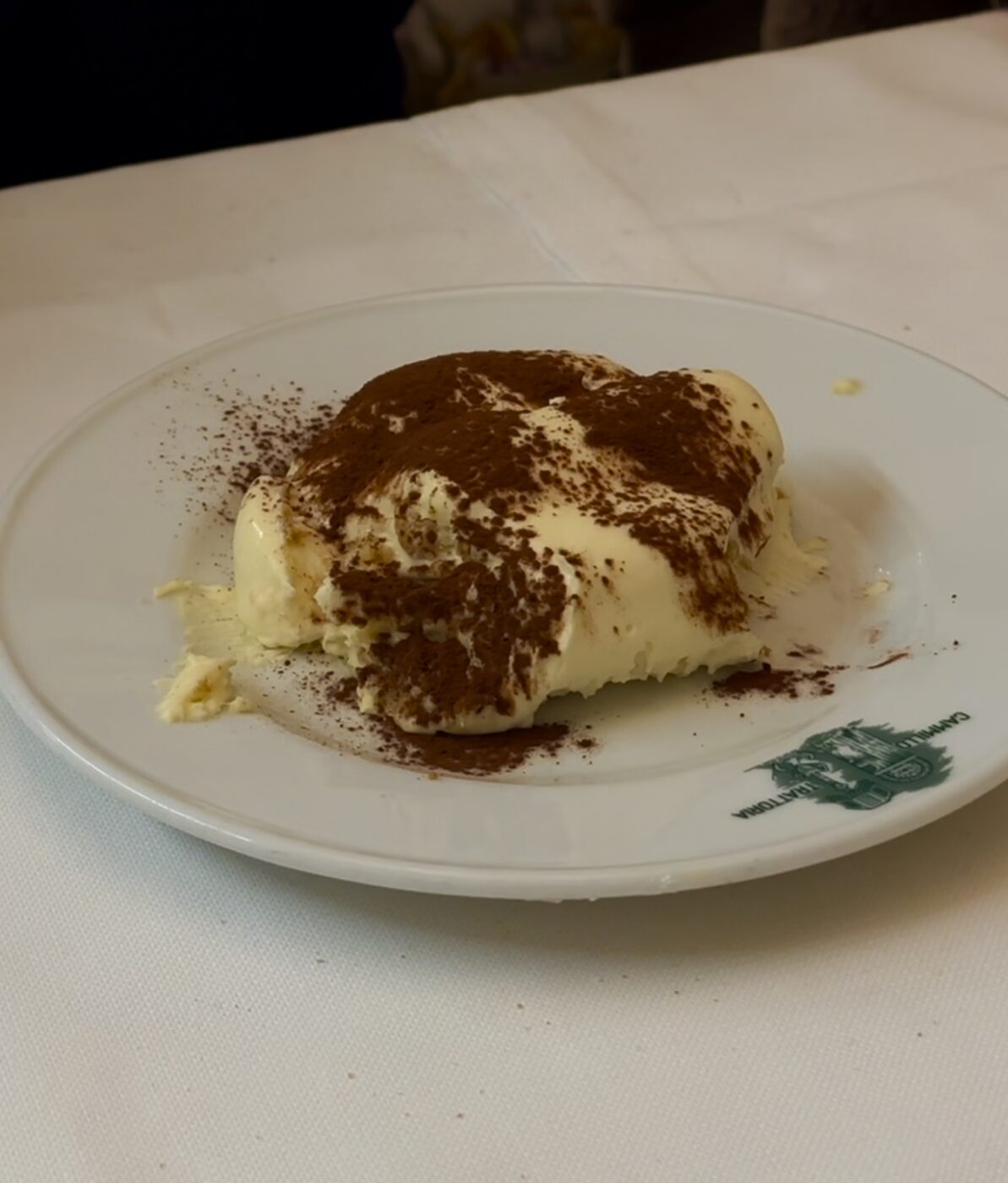 tiramisù on a plate on a table with a white table cloth