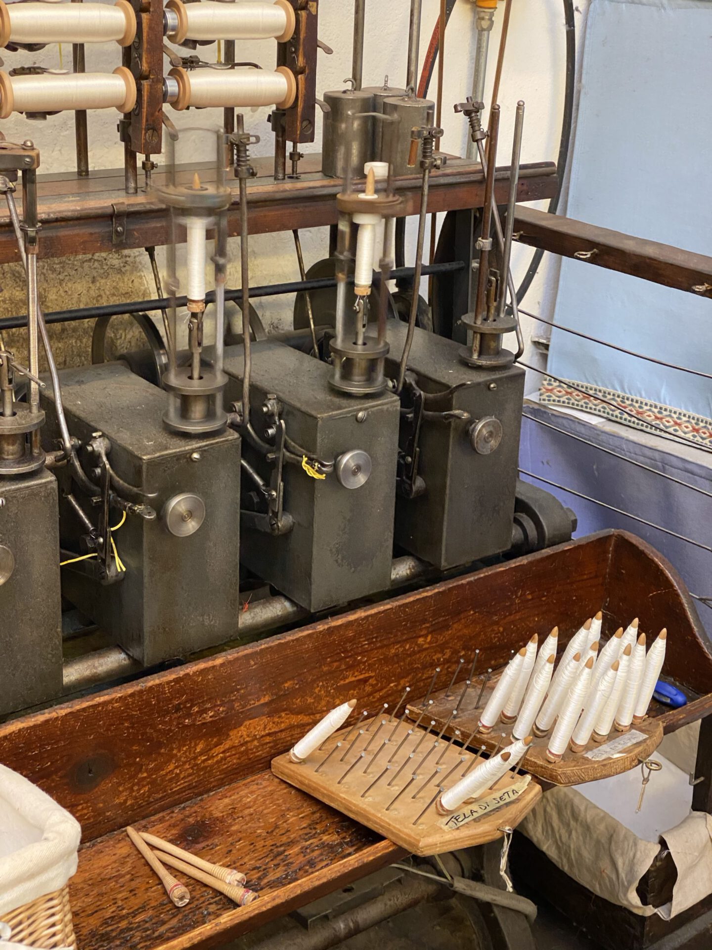 Wooden antique silk warper with white fabric in Old Silk Factory Setificio Fiorentino in Florence Tuscany in Italy