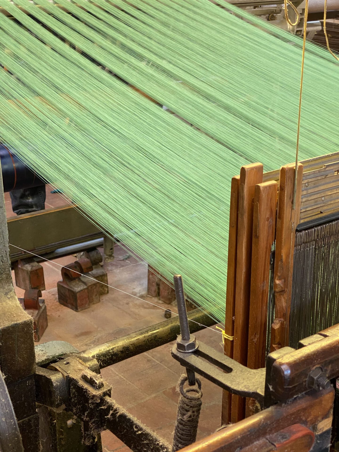 Wooden antique silk warper with green threads in Old Silk Factory Setificio Fiorentino in Florence Tuscany in Italy