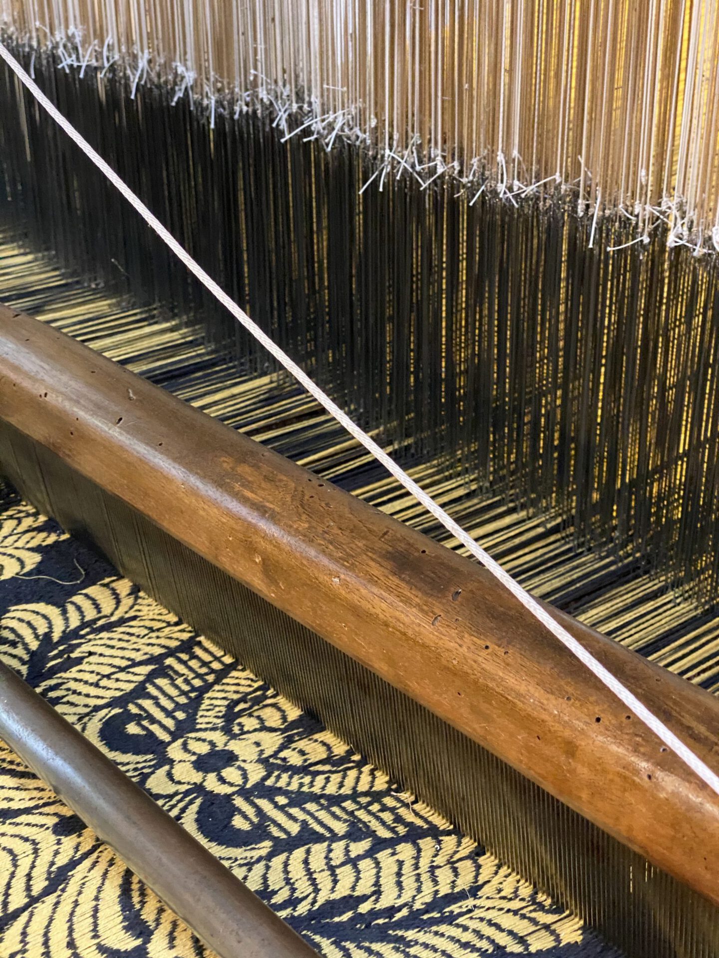 Wooden antique silk warper with blue and gold fabric in Old Silk Factory Setificio Fiorentino in Florence Tuscany in Italy