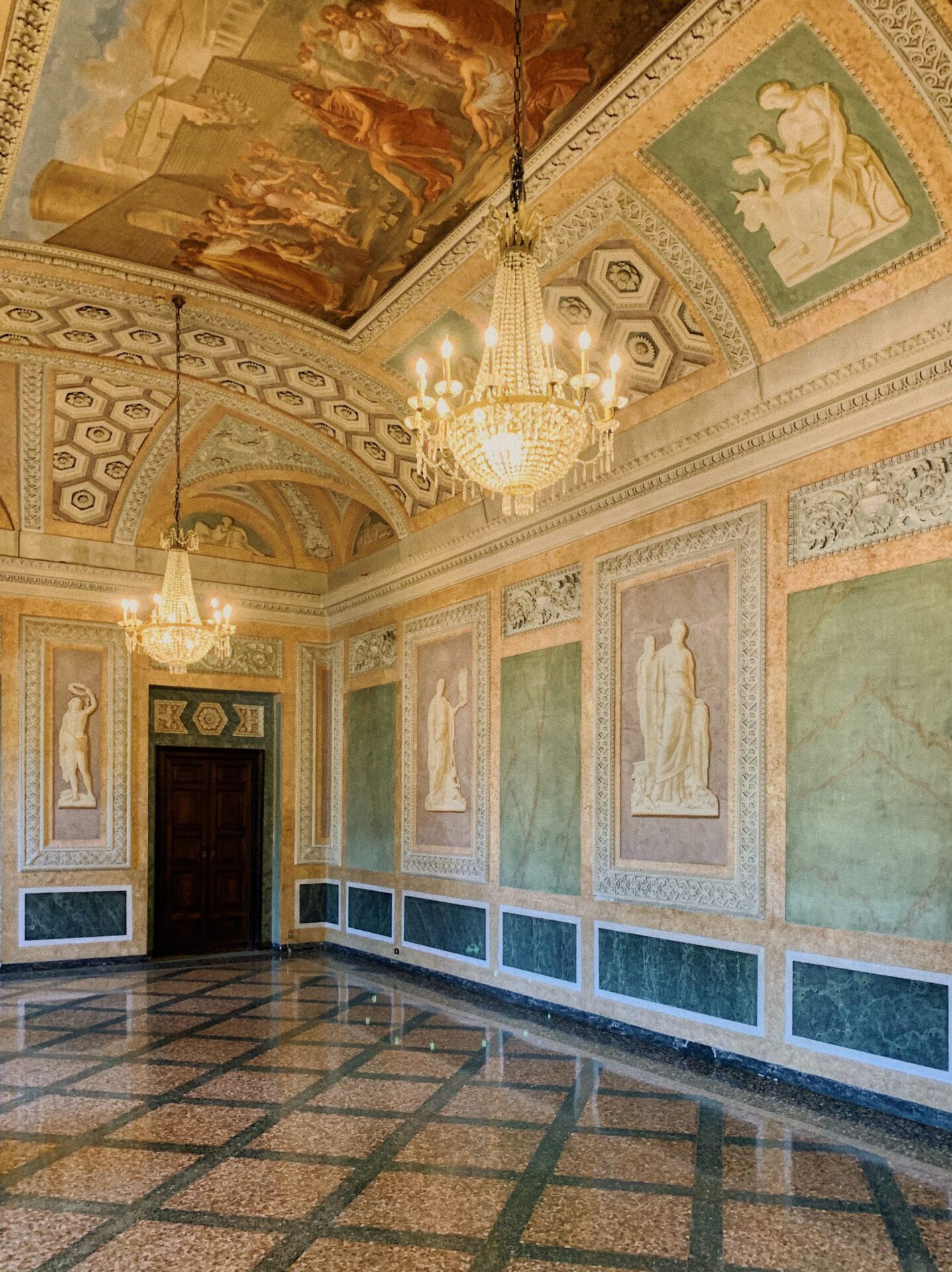 Neoclassic space with marble and yellow decoration and filled up with sculptures in Villa Olmo in Varenna Lombardy in Italy