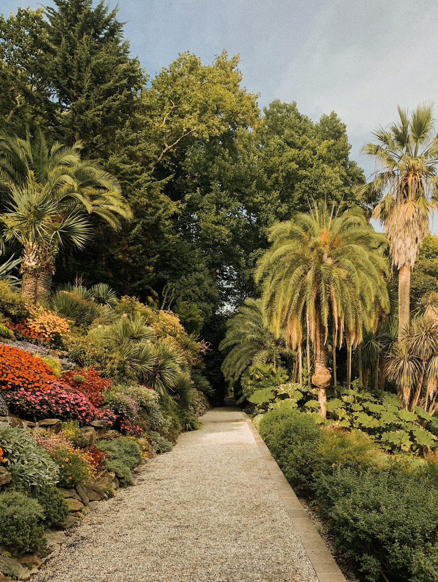 Antique crosswalk surrounded by plants and geometric gardens of Villa Carlotta in Tremezzo Lombardy in Italy