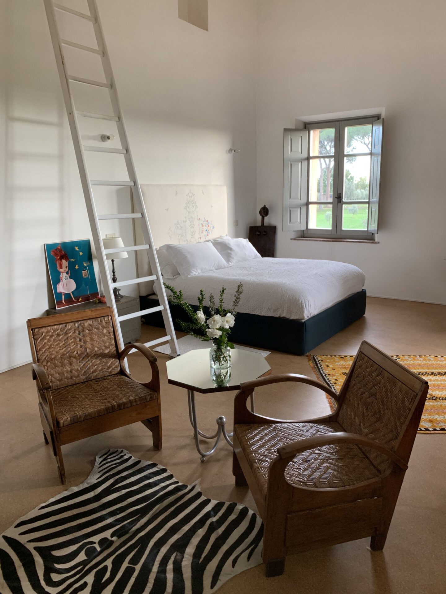 Minimalistic style bedroom with wooden furniture white walls and big white stair in an equestrian farm, Tenuta di Paternostro in Tuscia Italy