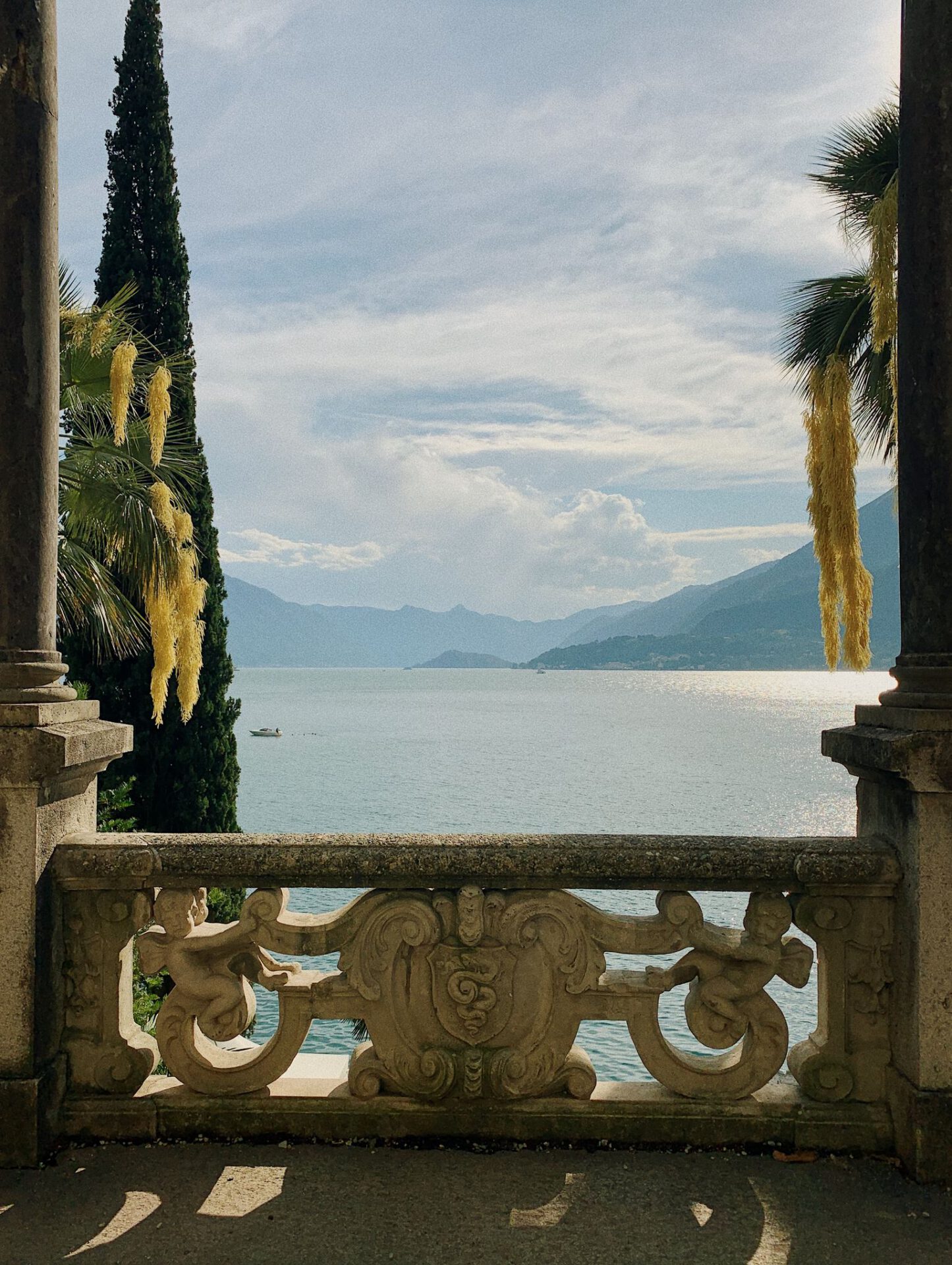 View of Lake Como from antique terrace in Villa Monastero with mountains in the background in Varenna Lombardy in Italy