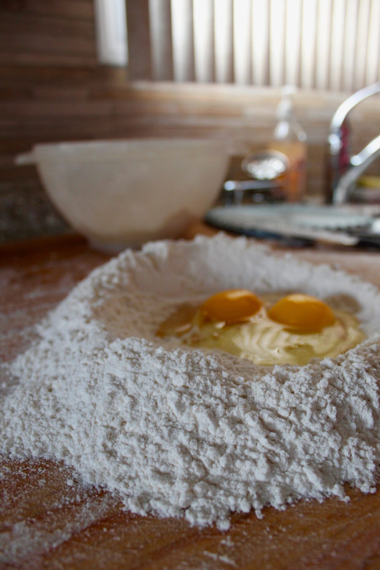 Fresh nocchi pasta making with flour and eggs over a typical wooden table in Roman kitchen