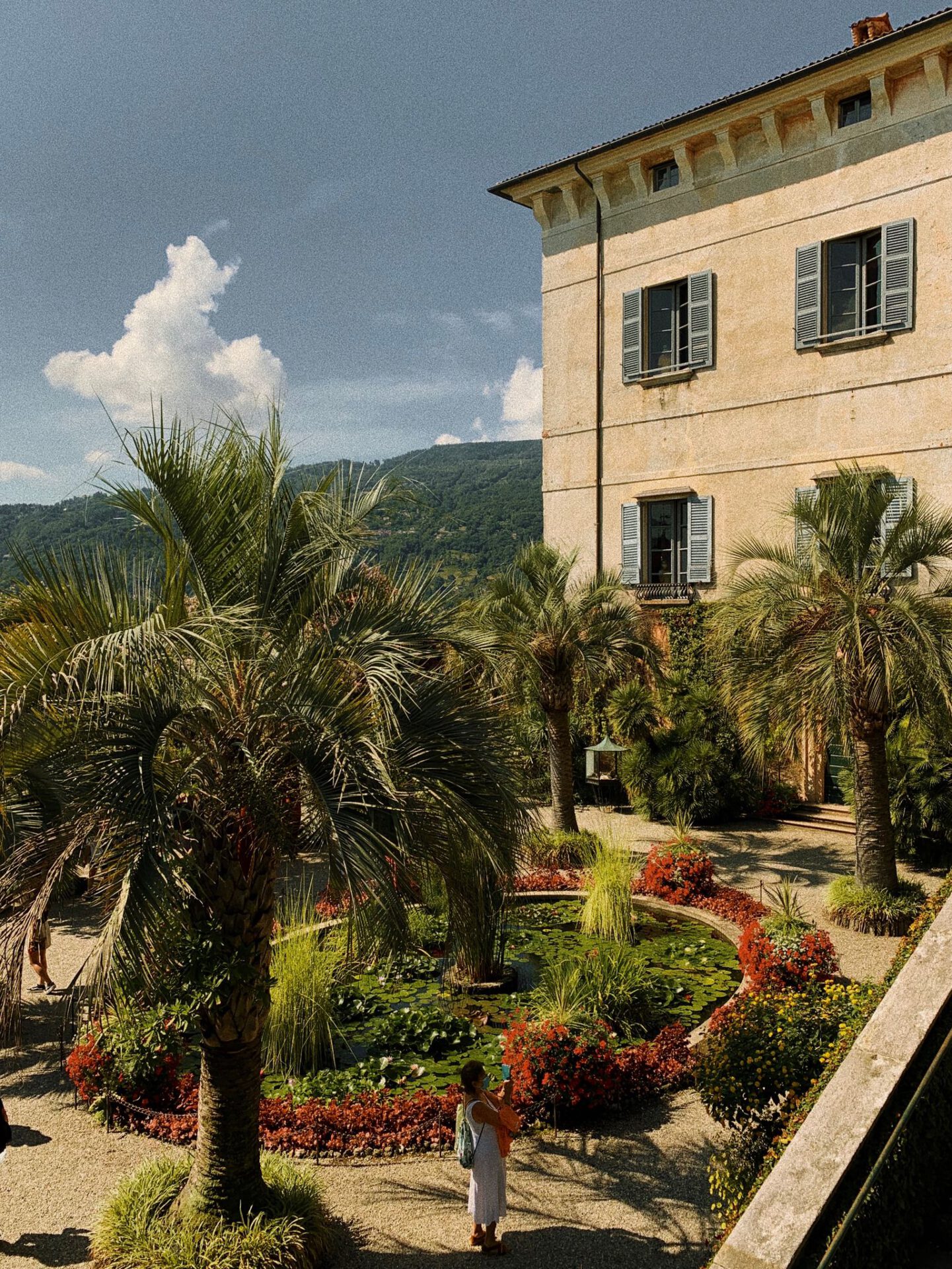 Antique building surrounded by plants and garden with mountains background in Isola Madre Lombardy in Italy