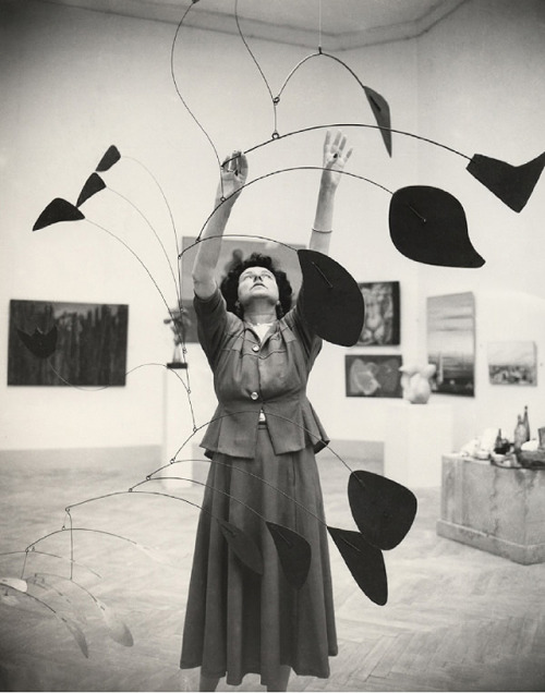 Peggy Guggenheim grey dressed organizing and art piece surrounded by paintings in black and white in Veneto Italy