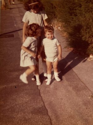 Vintage photography of a picture of three italian children dressed with the 70's style
