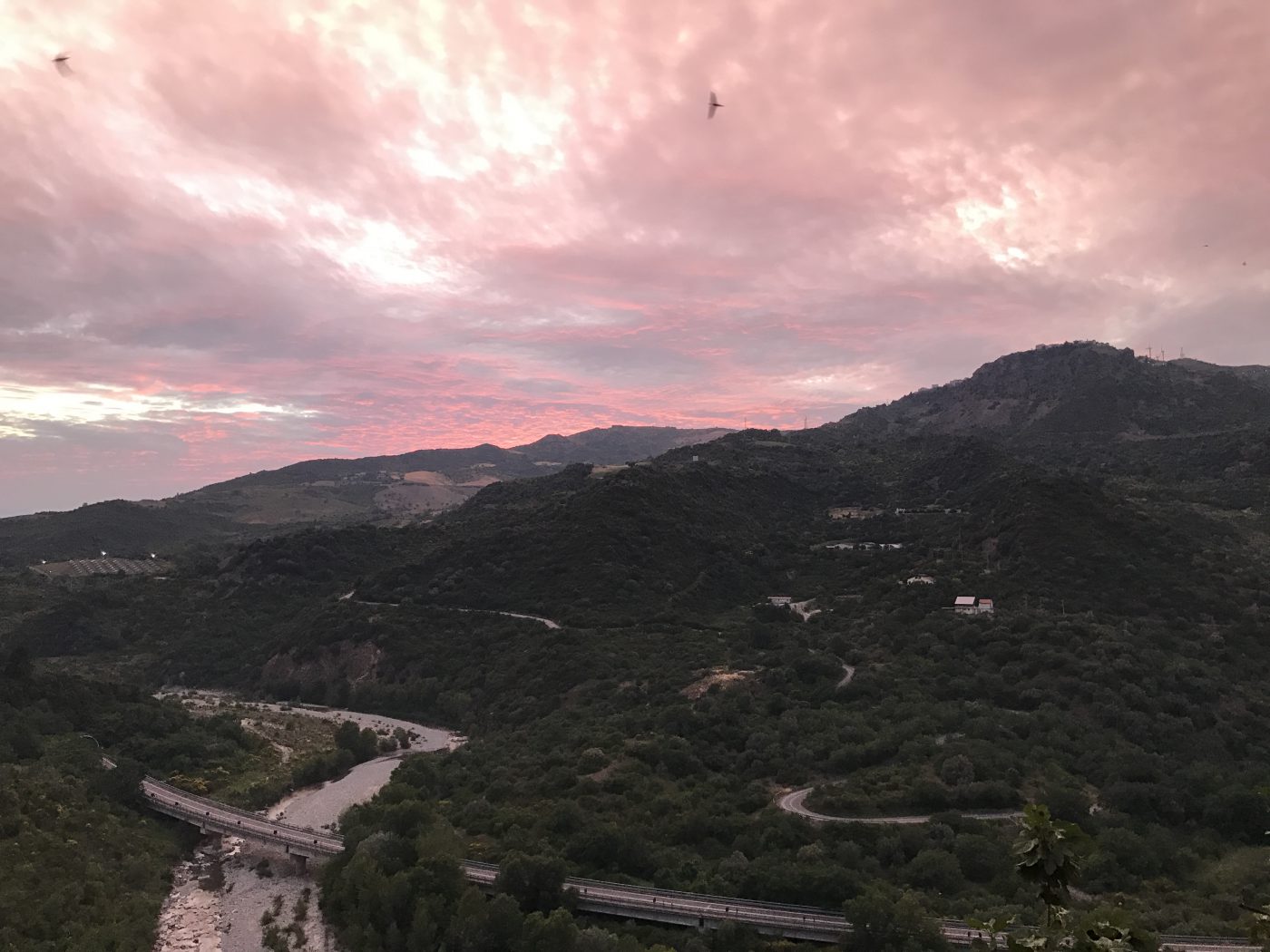 Sinni river with green mountains background and big bridge across in Basilicata Italy