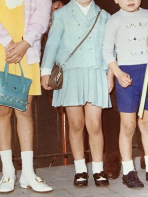 Photography of a picture of three italian children dressed with the 70's style