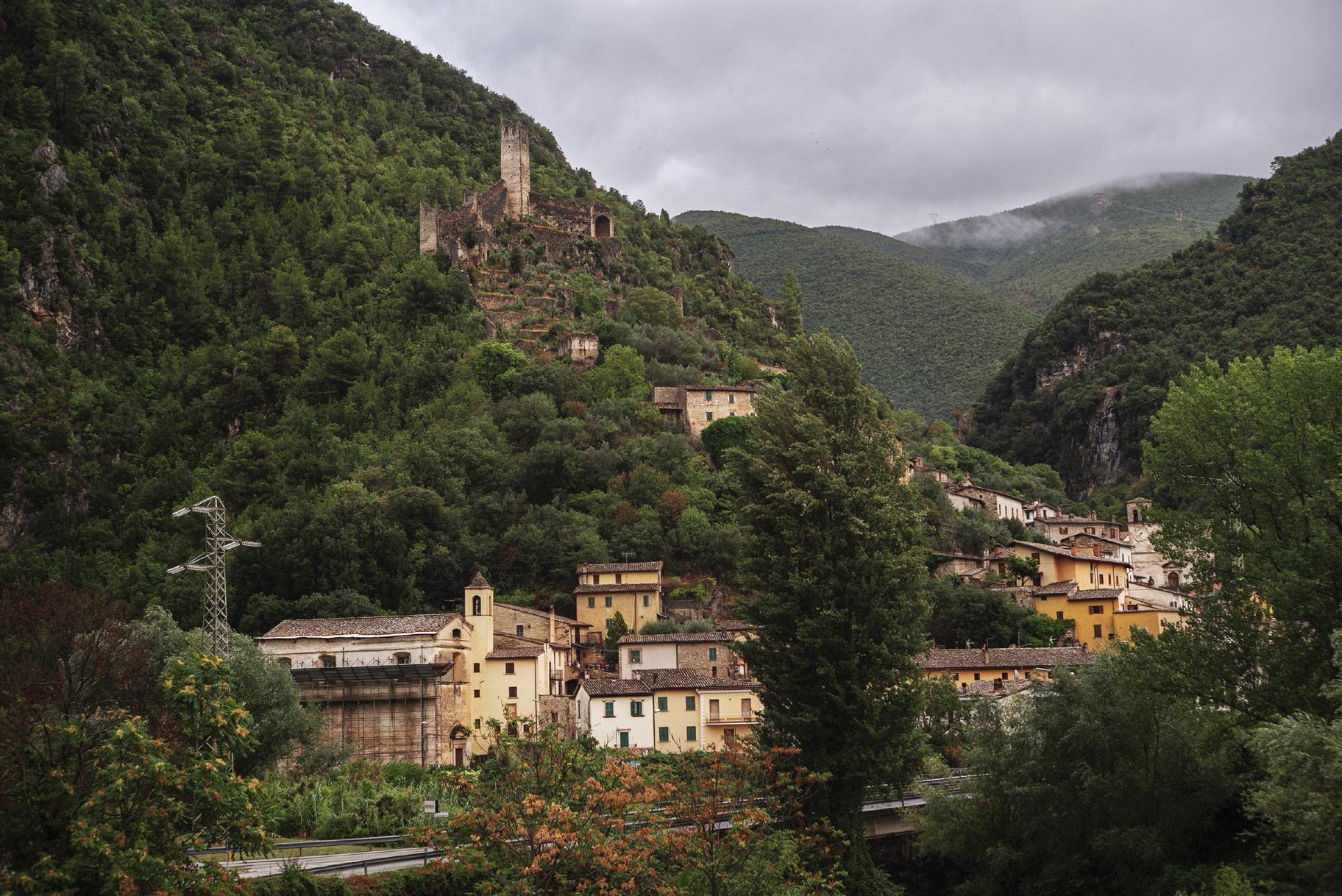 Antique houses and old castle in a hill surrounded by plants and mountains in Ferentillo Umbria in Italy