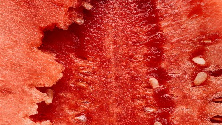 Close view of a bright red italian watermelon with seeds