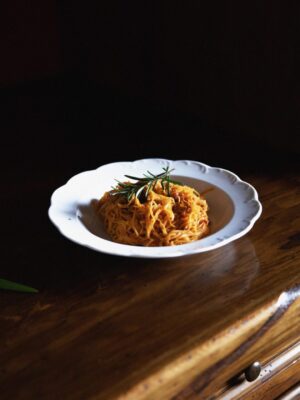 Stylish food over white ceramic plate and wooden furniture at Felicin Restaurant in Monforte d’Alba in Piedmont Italy