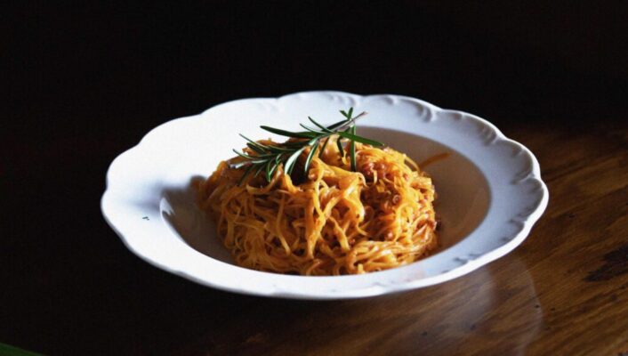 Stylish food over white ceramic plate and wooden furniture at Felicin Restaurant in Monforte d’Alba in Piedmont Italy