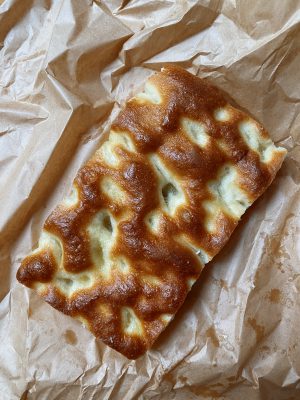 Schiacciata focaccia bread over paper bag in italy
