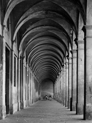a black and white image of porticos in Lucca
