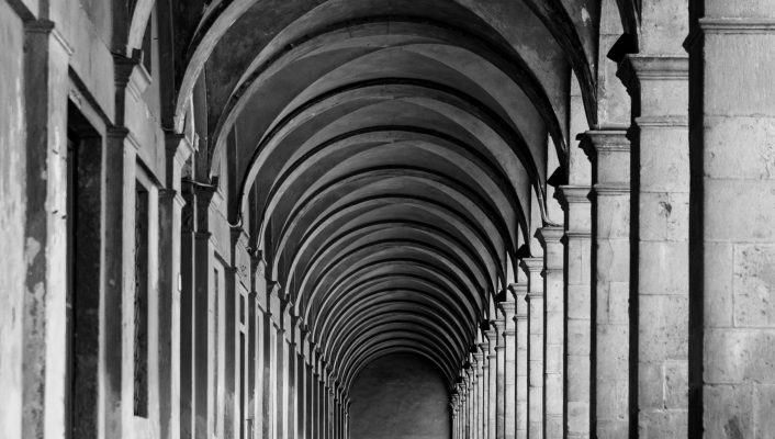 a black and white image of porticos in Lucca
