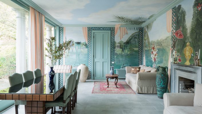 an internal room at La Foleia with a large dining table and beautiful frescos on the walls