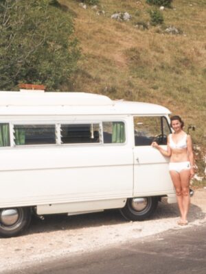 woman standing next to white van