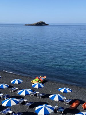 Blue and white striped umbrellas on the beach in Maratea, Basilicata