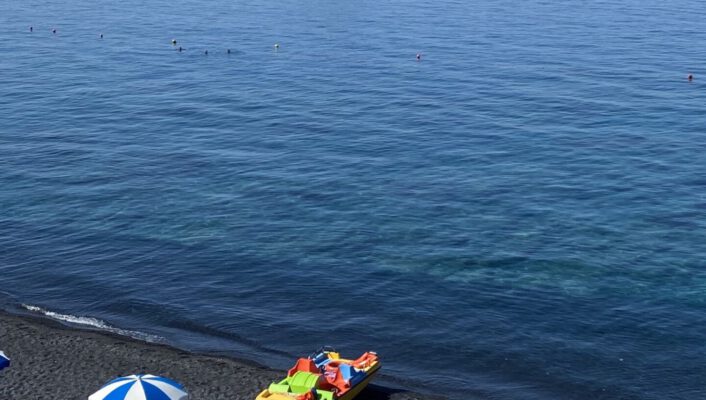 Blue and white striped umbrellas on the beach in Maratea, Basilicata