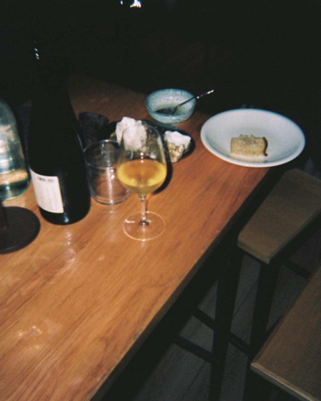 a glass of wine on a wooden table at enoteca lantidoto