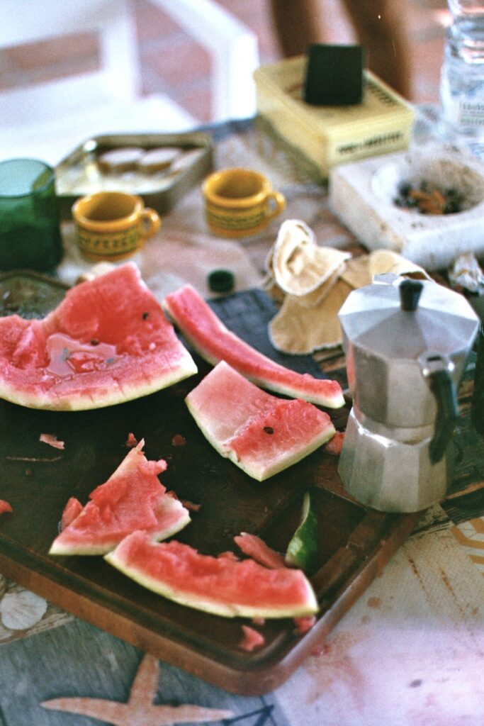 Pink watermelon, moka pots and yellow coffee cups