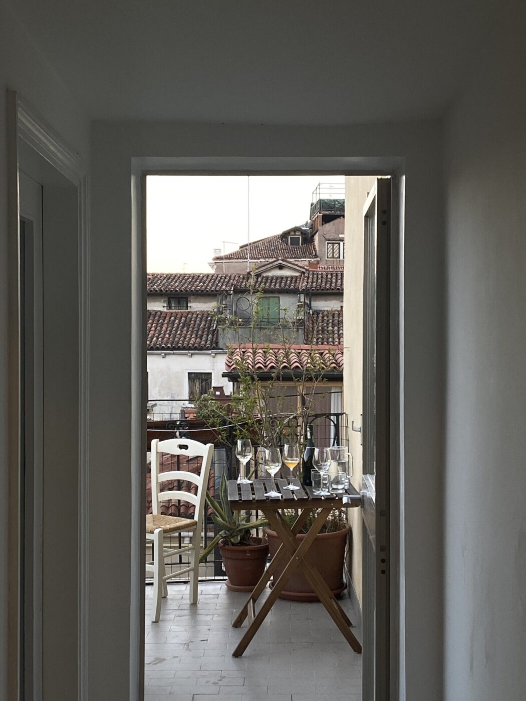 Venice, Venetian lifestyle, Veneto, altana, rooftops, terraces, window, Italy through a window, table with wine glasses