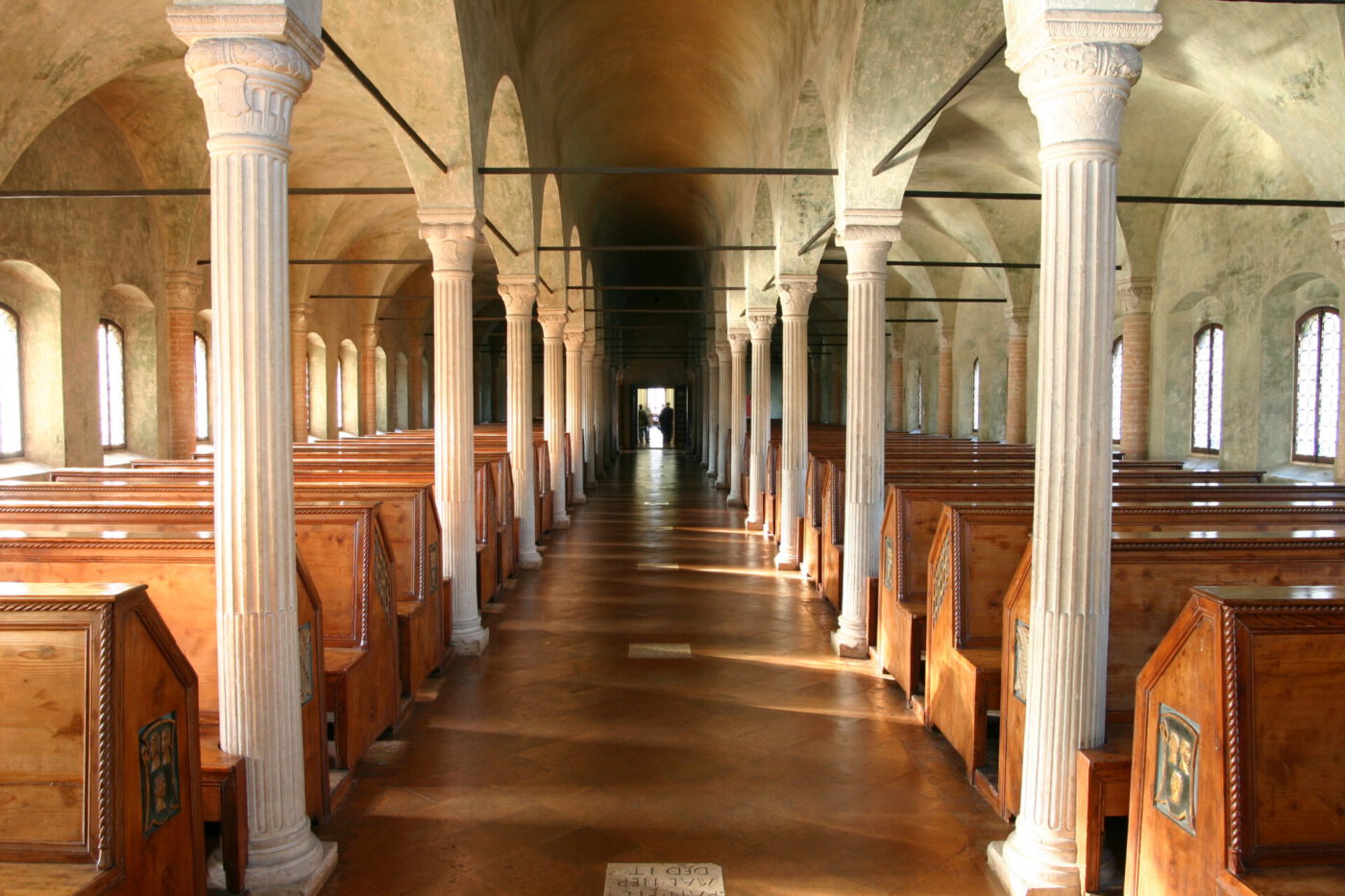a long row of reading booths in Biblioteca Malatestiana library in Cesena, Italy