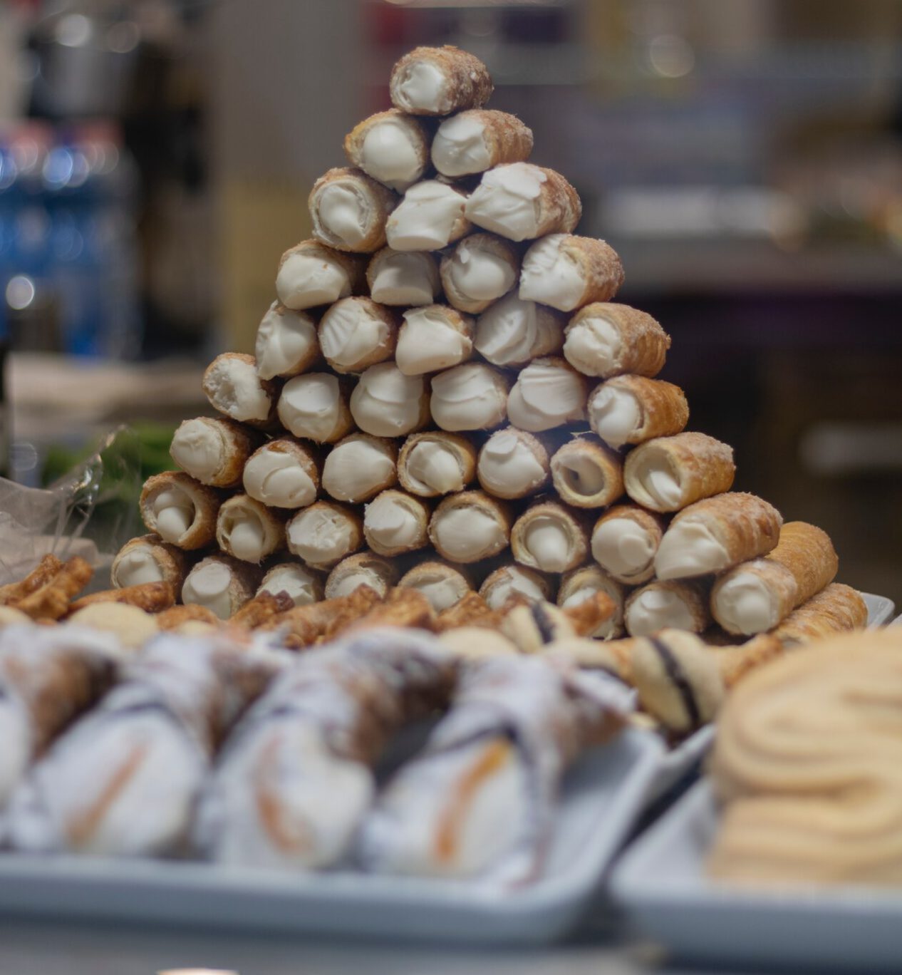 a pyramid of cannolis in a shop window in Palermo, Sicily