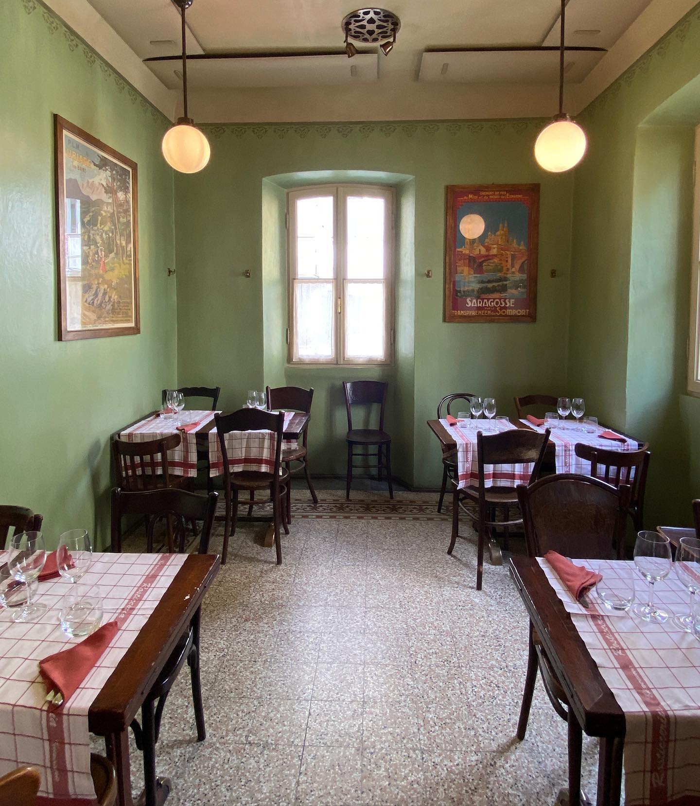 Traditional arranged wooden tables with tablecloth and glass at Giacomo Rosticceria Restaurant in Milan Piedmont in Italy