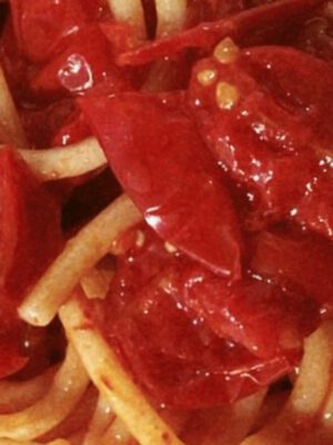 Close up of italian Spaghetti pasta with tomato sauce and crushed tomatoes