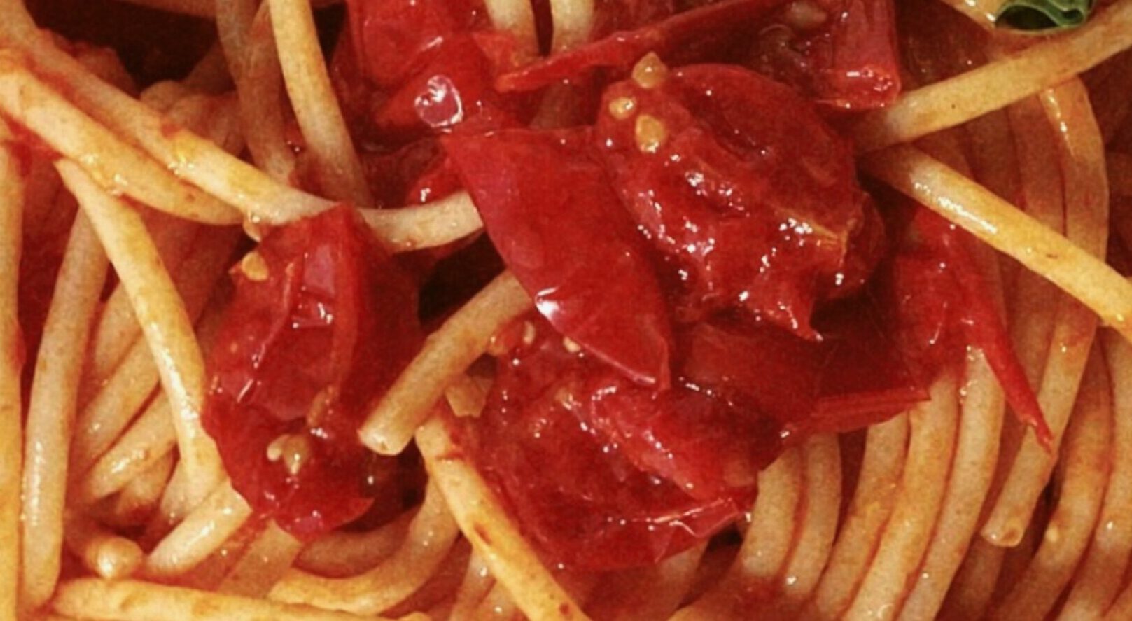 Close up of italian Spaghetti pasta with tomato sauce and crushed tomatoes