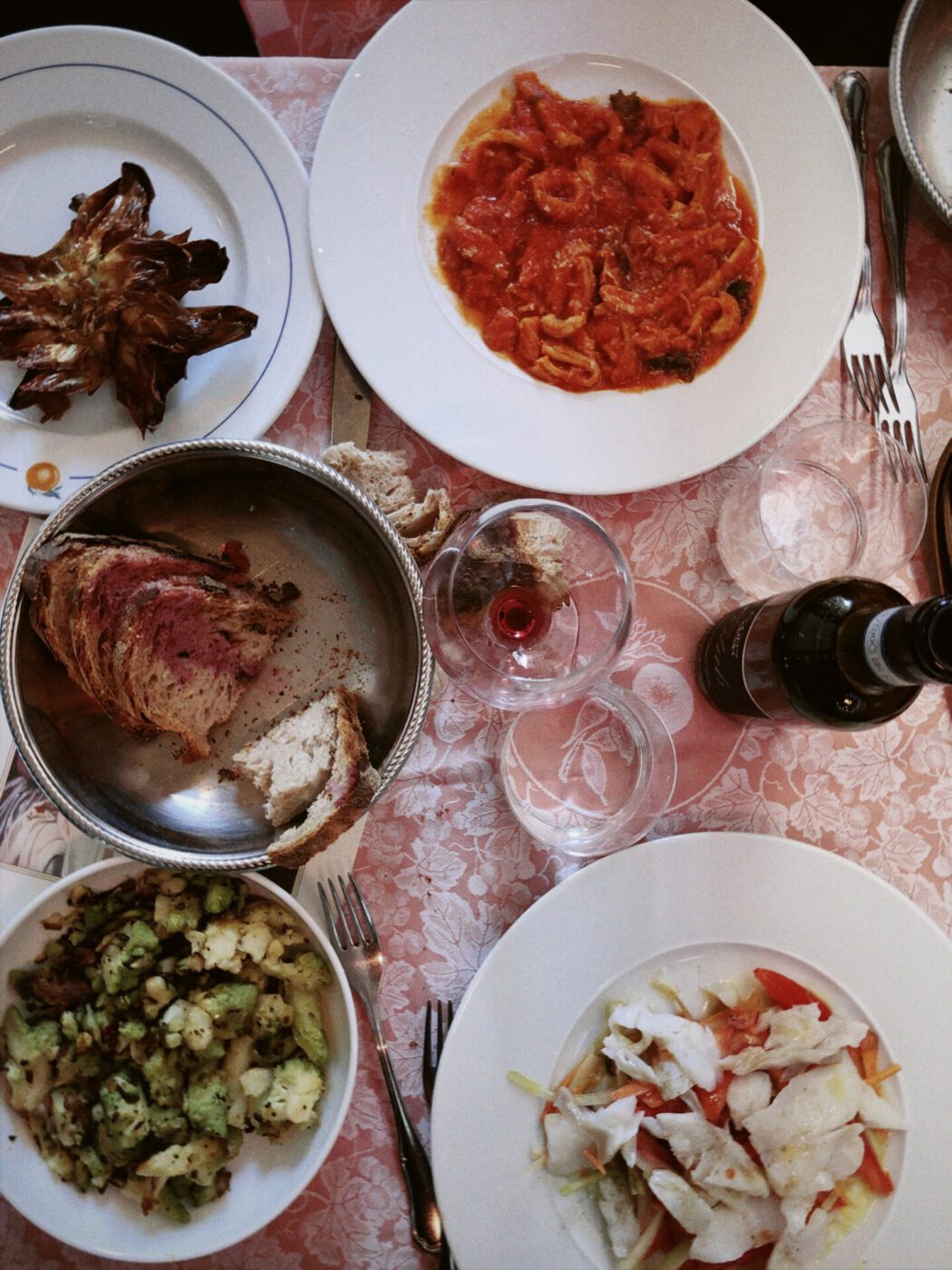 Traditional roman dishes like pasta carciofi alla giudia bread and wine at Settimio all'arancio restaurant in Rome Lazio in Italy