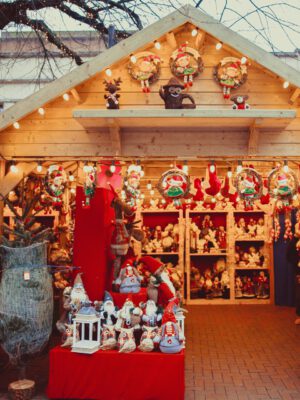 Castelrotto christmas market kiosk filled with christmas decoration lights and wooden structure in Alto Adige in Italy