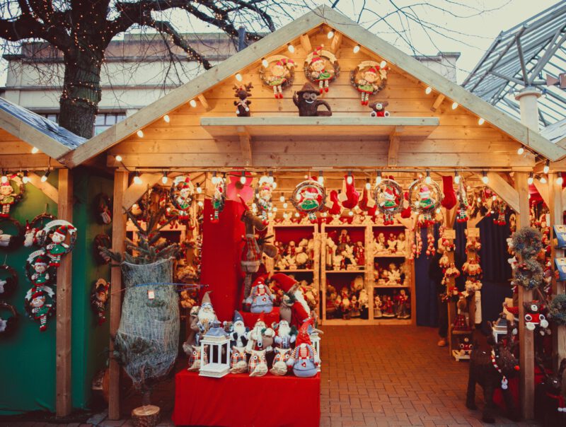 Castelrotto christmas market kiosk filled with christmas decoration lights and wooden structure in Alto Adige in Italy