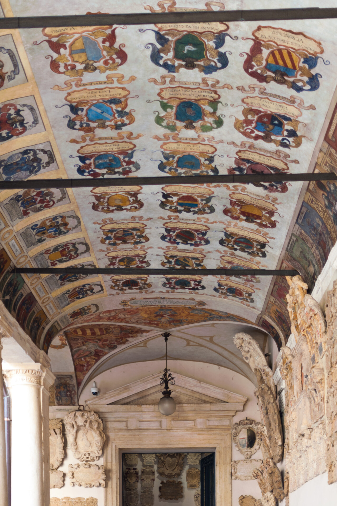 Families shields painted over the roof in colorful paints surrounded by sculptures and frames of at the Palazzo Bo in Padua Veneto in Italy